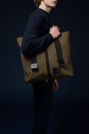 This image shows a person carrying The Angus Tote bag over their shoulder.